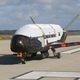 The X-37B Orbital Test Vehicle taxiing on a runway.